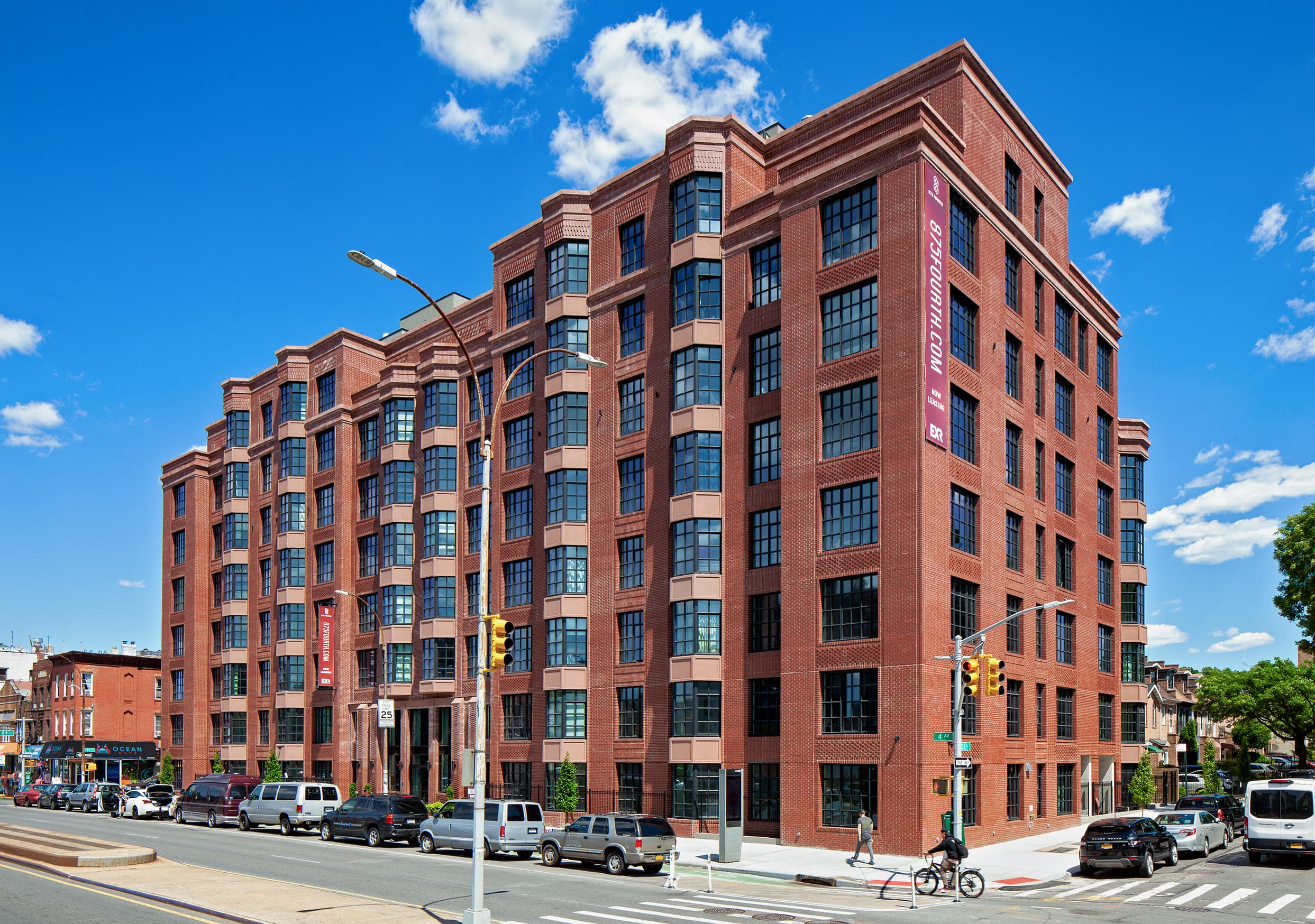 The brick exterior of 875 Fourth Avenue in Brooklyn on a clear day