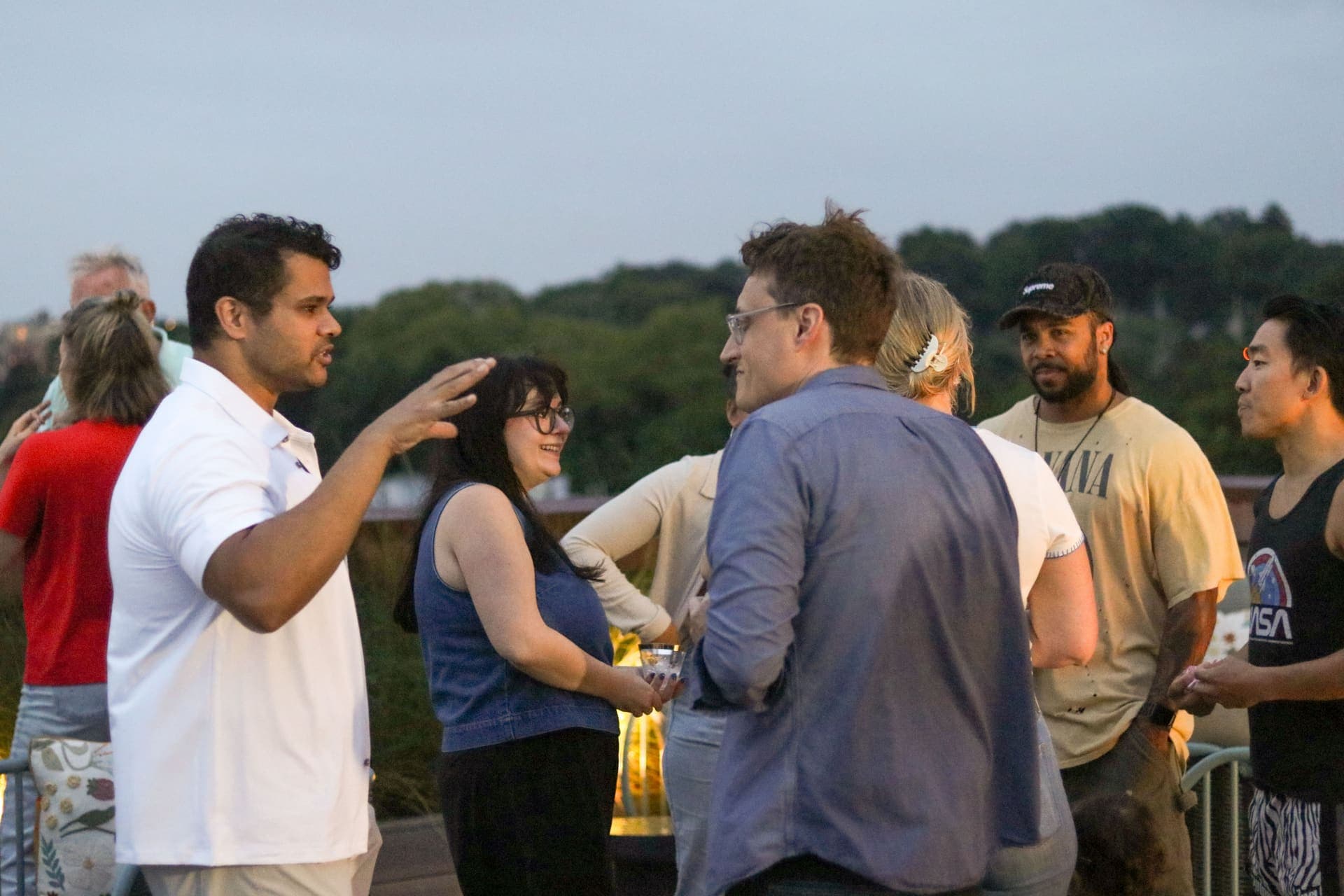 Residents talking together on the terrace after sunset at 875 Fourth Avenue