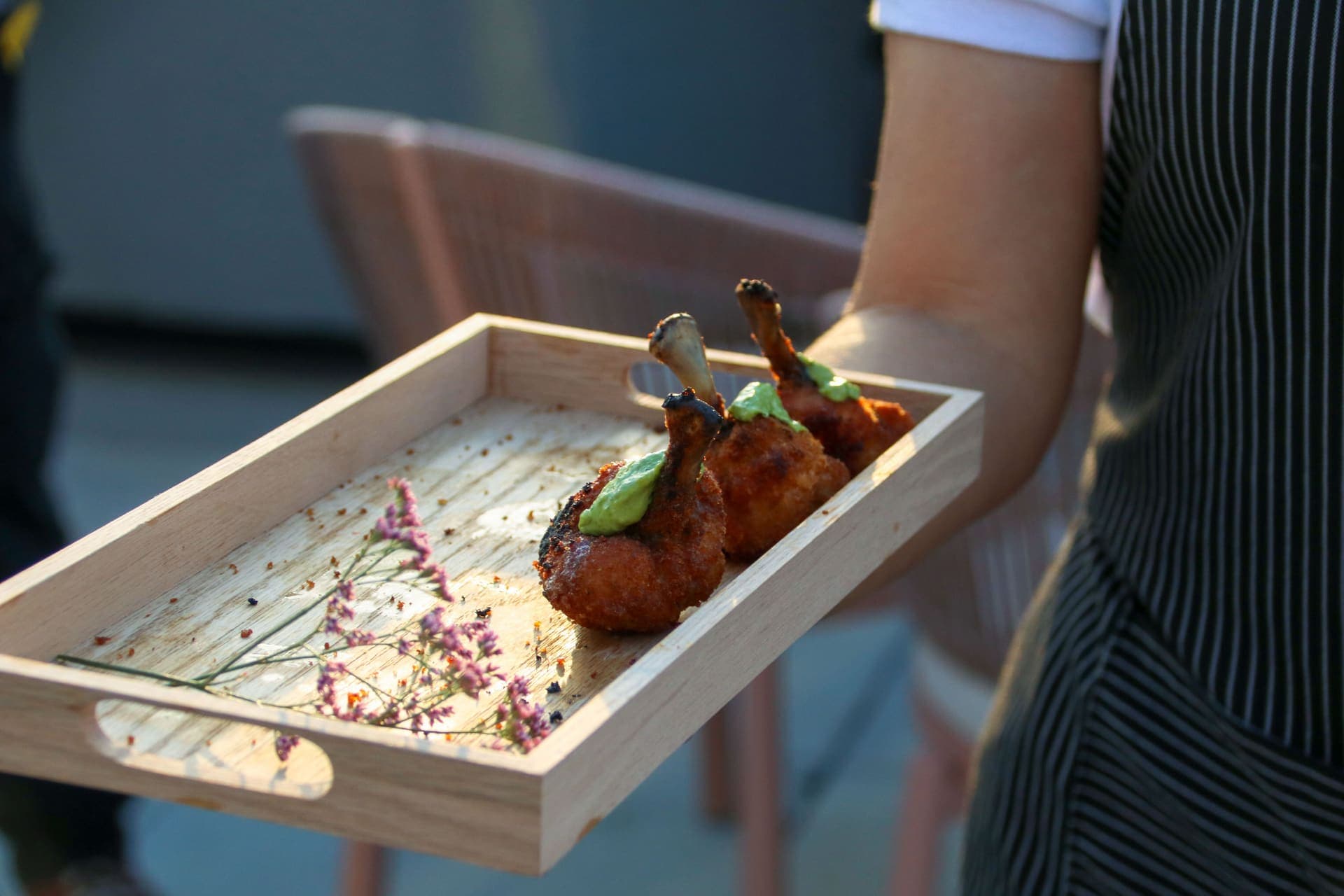 A tray of passed appetizers being served on the rooftop terrace at 875 Fourth Avenue