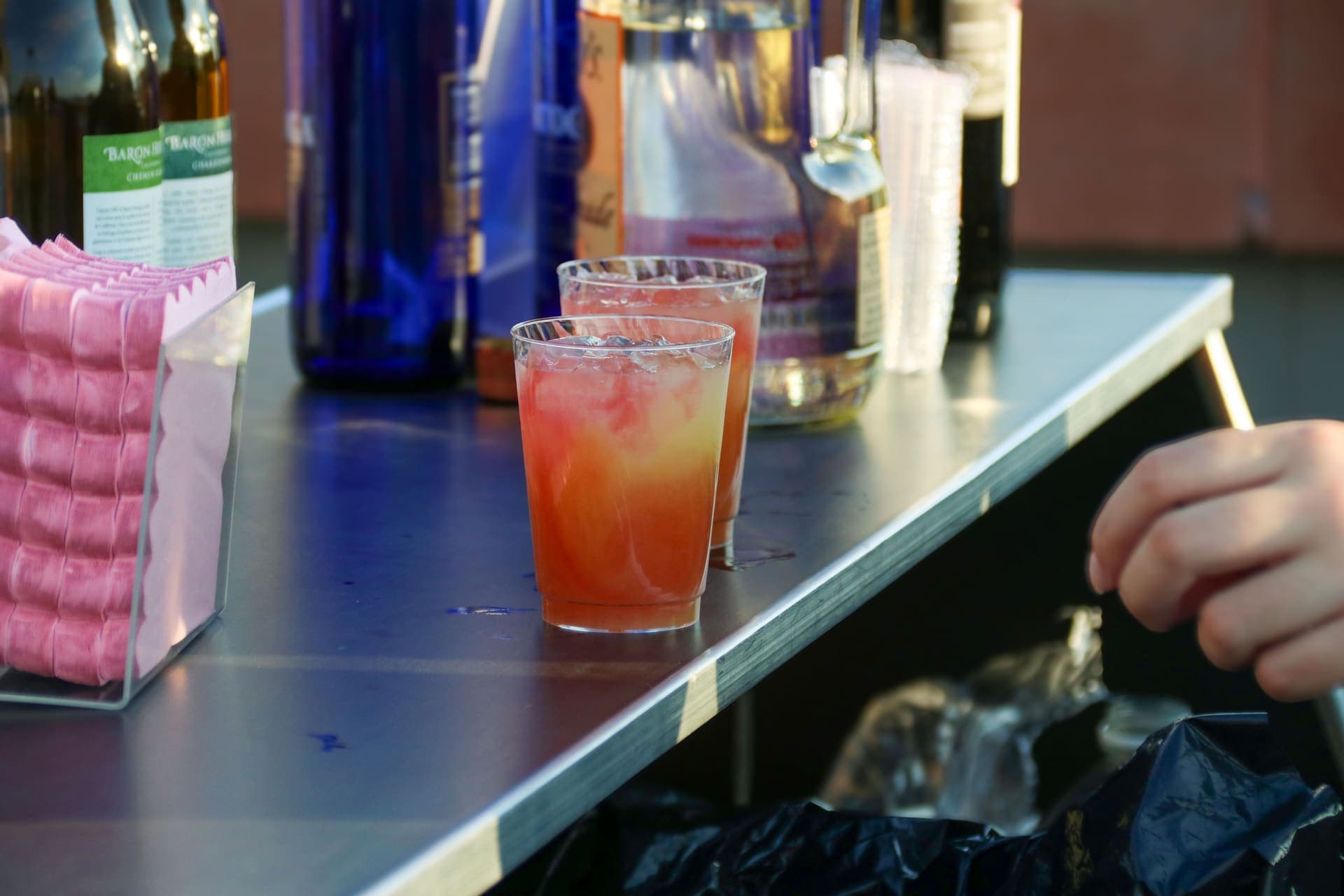 Cocktails lined up on the bar on the rooftop terrace at 875 Fourth Avenue
