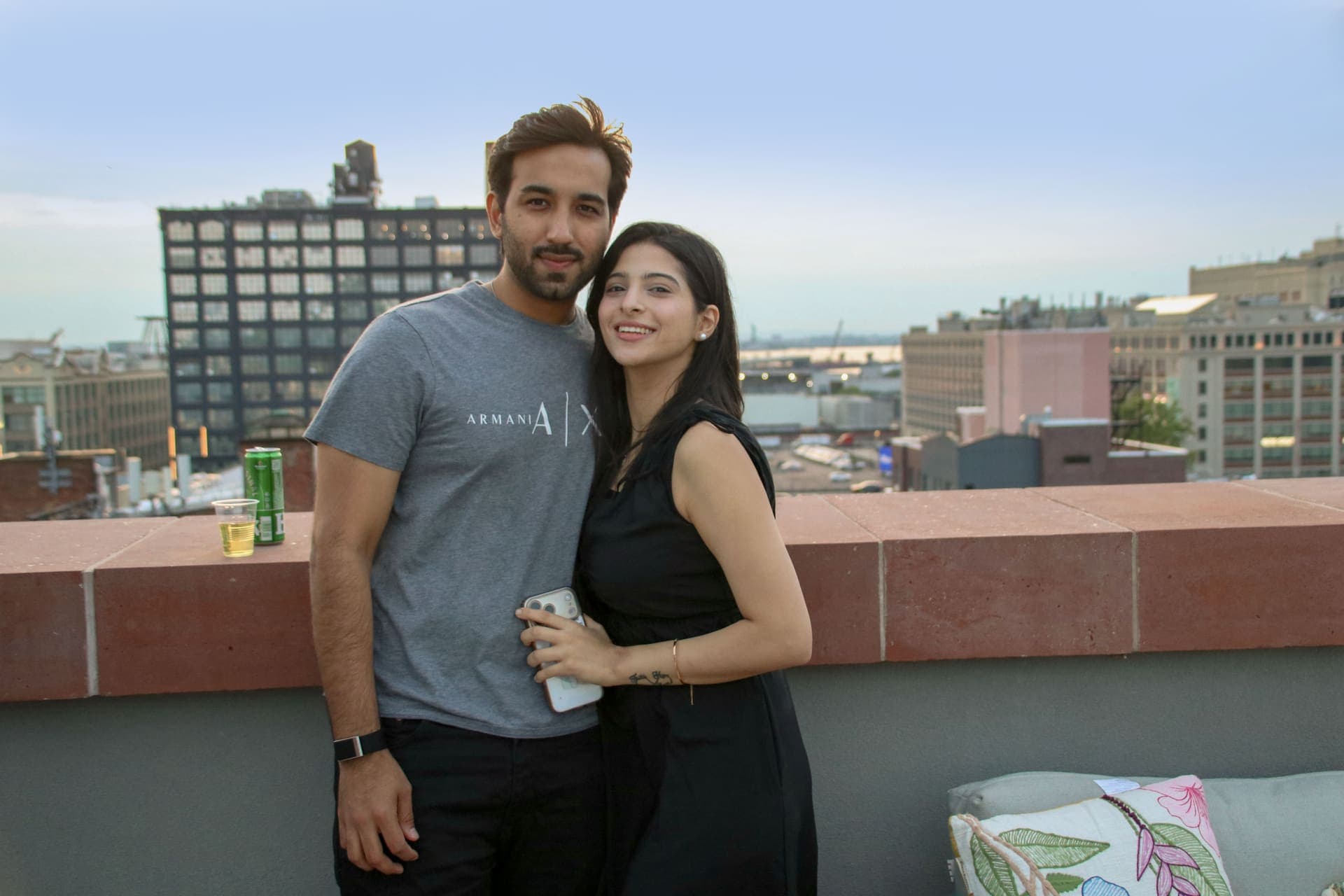 A couple photographed together with the skyline behind them on the rooftop terrace at 875 Fourth Avenue