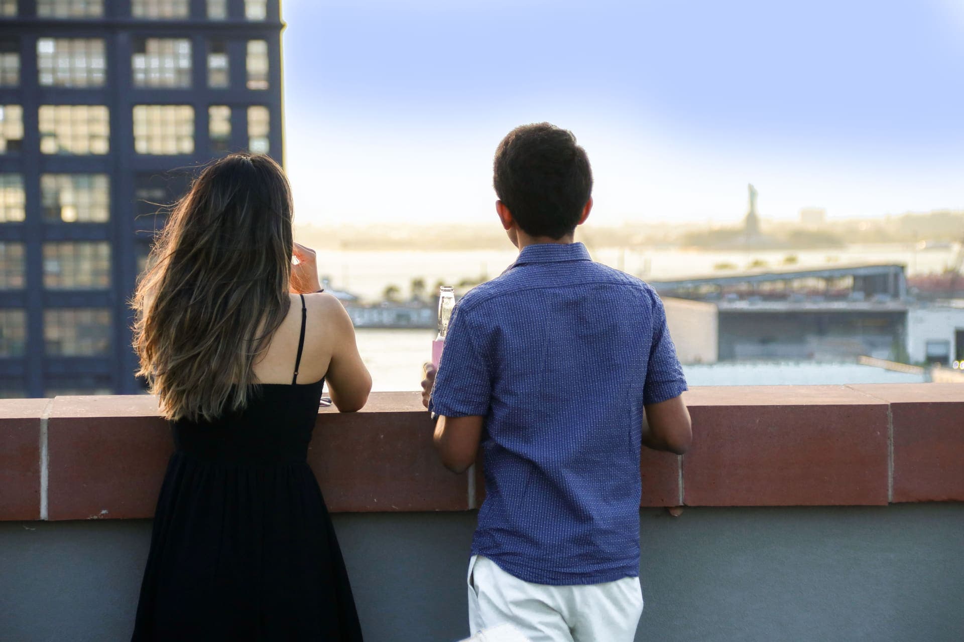 A couple taking in the harbor and skyline from the rooftop terrace at 875 Fourth Avenue