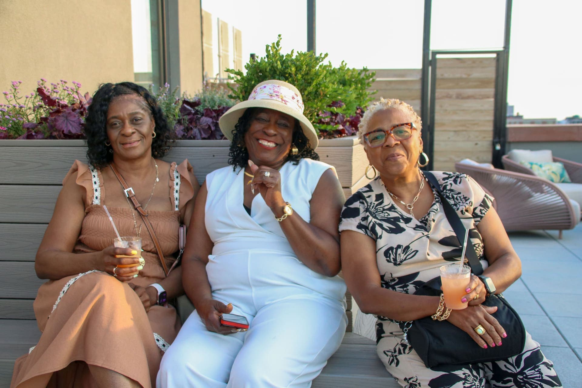 Neighbors relaxing together on a terrace bench with drinks in hand at 875 Fourth Avenue