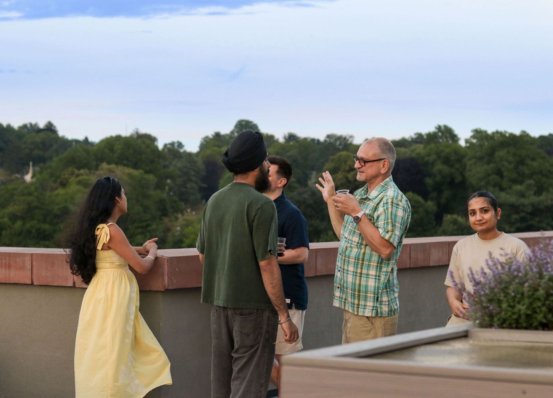 Residents talking together beside the terrace greenery at 875 Fourth Avenue