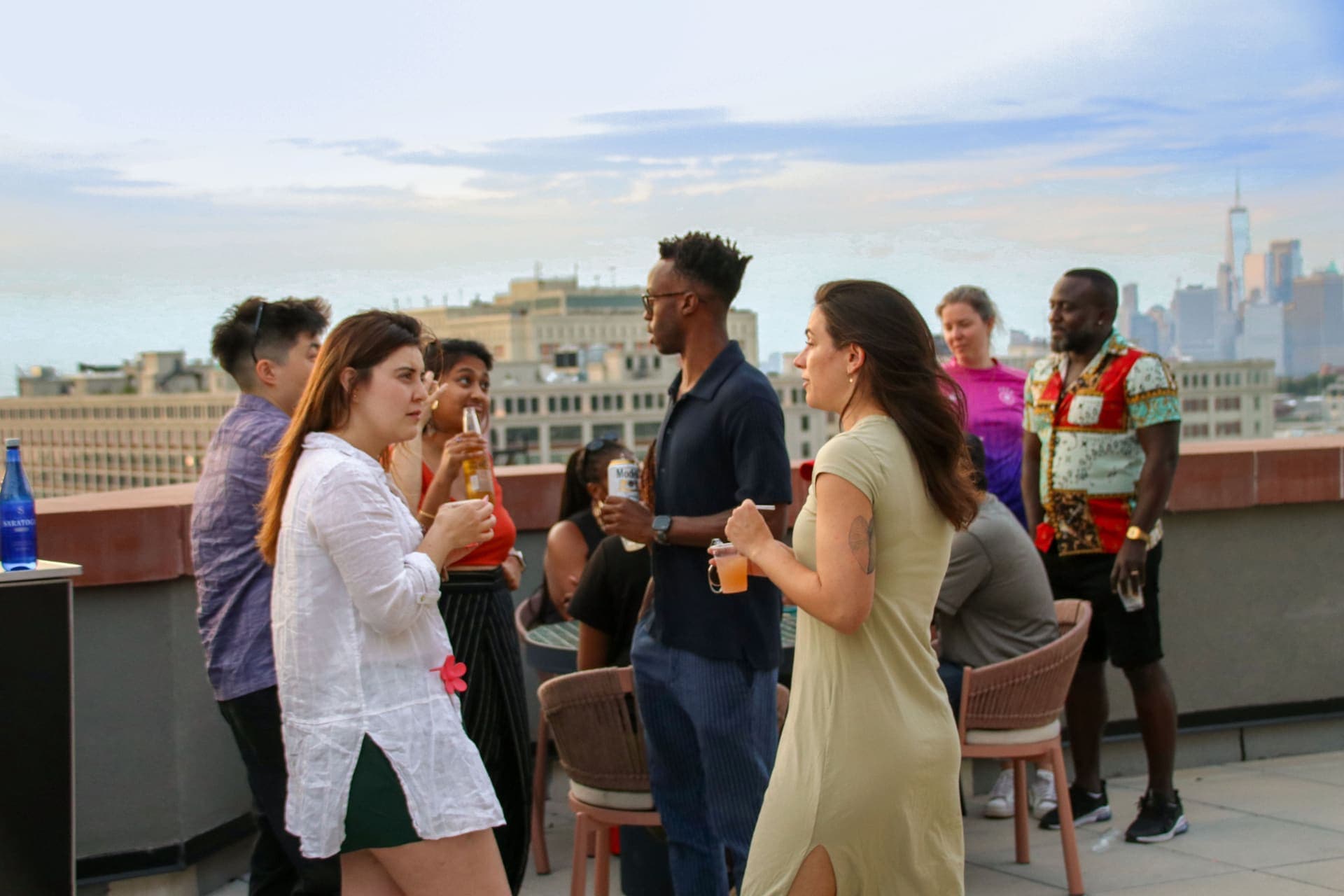 Residents in easy conversation over drinks on the rooftop terrace at 875 Fourth Avenue