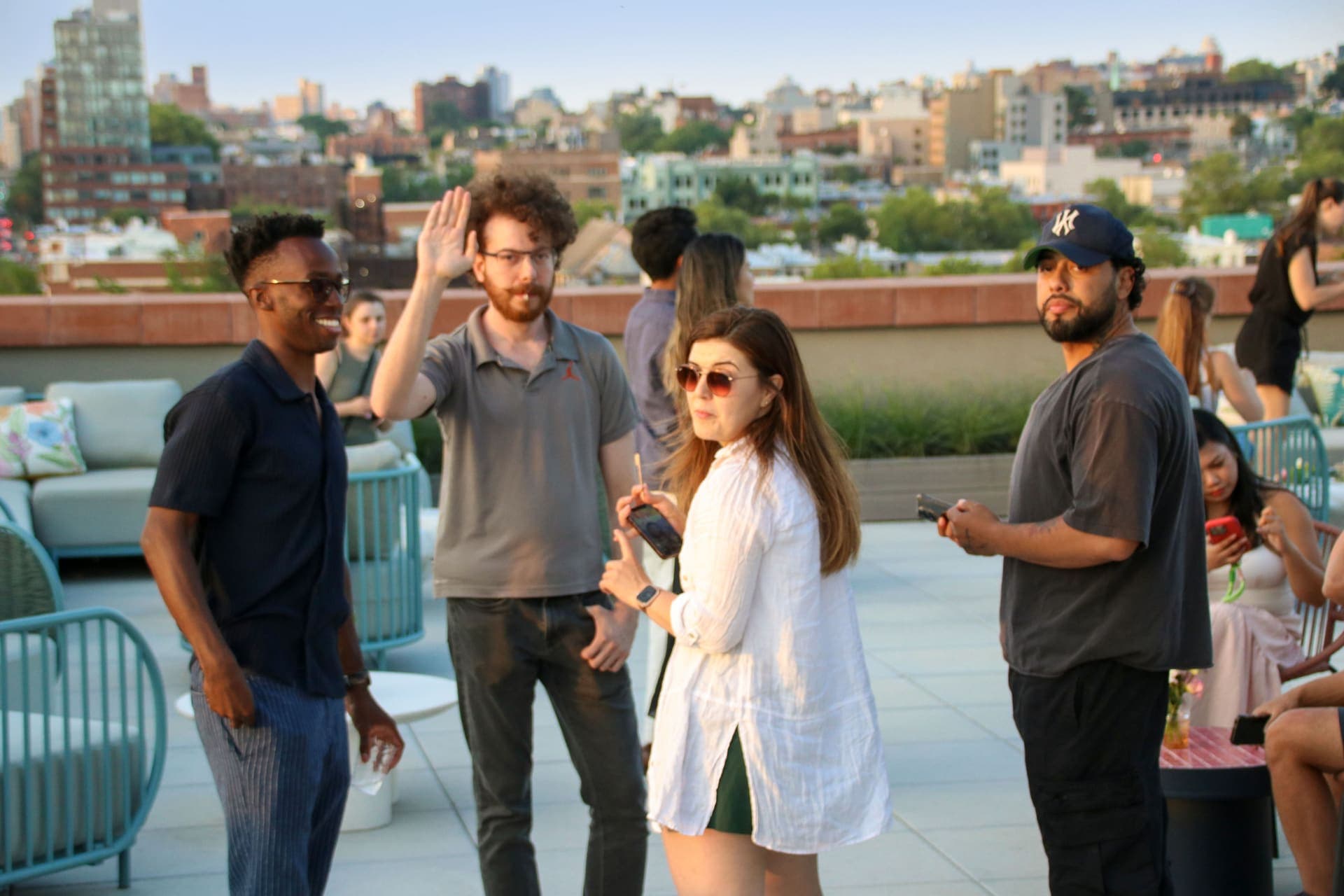 Residents mingling on the rooftop terrace at 875 Fourth Avenue as one waves to friends