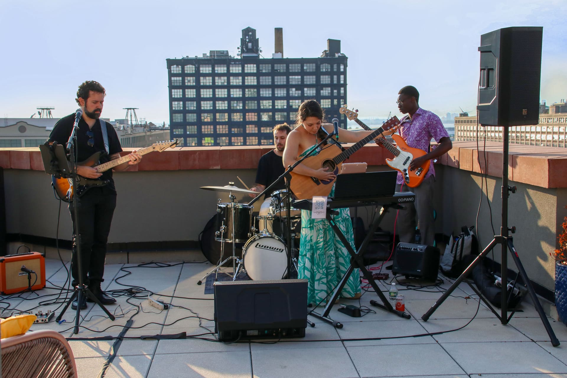 A live band performing against the Manhattan skyline on the rooftop terrace at 875 Fourth Avenue